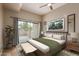 Bright main bedroom with balcony access, ceiling fan, neutral decor, and an ensuite bathroom at 205 N 74Th St # 166, Mesa, AZ 85207