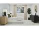 Bright bedroom with modern decor, decorative rug, bedside table, and large window offering lots of light at 20901 S 231St Way, Queen Creek, AZ 85142