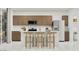 Bright kitchen featuring wood cabinets, a breakfast bar with seating, and stainless steel appliances at 20901 S 231St Way, Queen Creek, AZ 85142