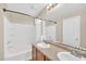 Bright bathroom with a double sink vanity, large mirror, and a shower-tub combo at 2118 N 77Th Ln, Phoenix, AZ 85035