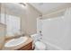 Well-maintained bathroom with a single vanity, ample counter space, and a shower-tub combination with white tile at 2118 N 77Th Ln, Phoenix, AZ 85035