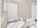 Bright bathroom features a large mirror, vanity and sink with toilet and bath/shower combo at 2118 N 77Th Ln, Phoenix, AZ 85035