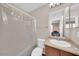 Bathroom with a sink, toilet and shower/tub featuring neutral colors and a well lit mirror at 2118 N 77Th Ln, Phoenix, AZ 85035