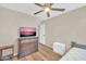 Bedroom featuring a ceiling fan, natural light from the window, and wood flooring at 2118 N 77Th Ln, Phoenix, AZ 85035