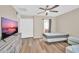 Bedroom featuring natural light, ceiling fan, and wood floors with a queen sized bed at 2118 N 77Th Ln, Phoenix, AZ 85035