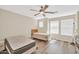 Bedroom featuring natural light, ceiling fan, and wood floors with two beds and side tables at 2118 N 77Th Ln, Phoenix, AZ 85035