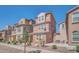 Inviting front exterior showcases a three-story home, tiled roof, stone accents, neat landscaping, and a cozy patio area at 2118 N 77Th Ln, Phoenix, AZ 85035
