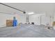 A large garage provides generous space for vehicles and storage, enhanced by good lighting and a sealed concrete floor at 2118 N 77Th Ln, Phoenix, AZ 85035