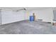 Spacious garage with ample room for parking and storage, featuring a clean concrete floor at 2118 N 77Th Ln, Phoenix, AZ 85035