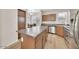 Well-equipped kitchen with stainless steel appliances, a central island, and abundant storage at 2118 N 77Th Ln, Phoenix, AZ 85035