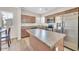 Modern kitchen with an island, stainless steel appliances, and ample cabinet space at 2118 N 77Th Ln, Phoenix, AZ 85035