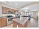 Stylish kitchen featuring stainless steel appliances, a central island, and an open layout at 2118 N 77Th Ln, Phoenix, AZ 85035