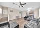 Spacious living room with modern furniture, wood floors, and abundant natural light at 2118 N 77Th Ln, Phoenix, AZ 85035