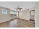 Spacious loft area features wood flooring, a ceiling fan, multiple windows, and an exit sign above a doorway at 2118 N 77Th Ln, Phoenix, AZ 85035