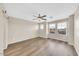 Expansive loft with wood floors, ceiling fan, and multiple windows, perfect for a flexible living or entertaining space at 2118 N 77Th Ln, Phoenix, AZ 85035