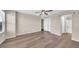 Open loft space with wood floors, ceiling fan, windows, and an en-suite bathroom, providing comfortable living at 2118 N 77Th Ln, Phoenix, AZ 85035