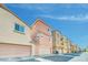 Row of townhomes featuring two-car garages, neutral color schemes and tile roofs at 2118 N 77Th Ln, Phoenix, AZ 85035