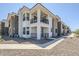 Modern two-story condo with stone accents, balcony, and well-maintained desert landscaping at 2121 W Sonoran Desert Dr # 32, Phoenix, AZ 85085
