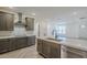 A modern kitchen with stone countertops, stainless steel appliances, and open floorplan at 2121 W Sonoran Desert Dr # 32, Phoenix, AZ 85085