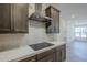 Modern kitchen with stainless steel range hood, cooktop, white backsplash, and ample countertop space at 2121 W Sonoran Desert Dr # 32, Phoenix, AZ 85085