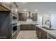 Open kitchen boasts stainless steel appliances, an island sink, and a breakfast bar at 2121 W Sonoran Desert Dr # 32, Phoenix, AZ 85085