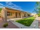 Exterior view of covered patio, turf backyard and low maintenance desert landscaping at 2183 W Hawken Way, Chandler, AZ 85286