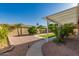 Manicured backyard showcasing desert landscaping, turf, and covered patio area at 2183 W Hawken Way, Chandler, AZ 85286