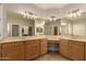 Bright bathroom featuring a vanity with double sinks, expansive mirrors, and cabinetry, offering modern luxury and convenience at 2183 W Hawken Way, Chandler, AZ 85286