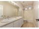 Bright bathroom with dual sinks, neutral walls, and a shower-tub combination at 2183 W Hawken Way, Chandler, AZ 85286