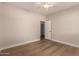 Light-filled bedroom with ceiling fan, neutral walls, and wood-look flooring at 2183 W Hawken Way, Chandler, AZ 85286