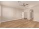 Bedroom showcasing wood floors, a ceiling fan, and an open doorway to the ensuite, creating a spacious retreat at 2183 W Hawken Way, Chandler, AZ 85286