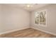 Well-lit bedroom boasts wood-look flooring and a bright window adorned with plantation shutters at 2183 W Hawken Way, Chandler, AZ 85286