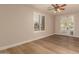 Bright bedroom features wood-look flooring, neutral walls, plantation shutters, and double doors to the patio at 2183 W Hawken Way, Chandler, AZ 85286