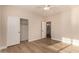 Bright bedroom features a closet with sliding doors, neutral walls, and modern wood-look flooring at 2183 W Hawken Way, Chandler, AZ 85286
