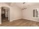 Dining room with wood floors, chandelier, shutters, and access to living area at 2183 W Hawken Way, Chandler, AZ 85286