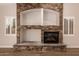 Stone fireplace with mantle and hearth flanked by windows with shutter coverings at 2183 W Hawken Way, Chandler, AZ 85286