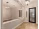 Home showcasing tiled floors, iron security door, decorative light fixtures, and bright lighting at 2183 W Hawken Way, Chandler, AZ 85286