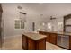 Modern kitchen featuring granite counters, island, pendant lights, and stainless dishwasher at 2183 W Hawken Way, Chandler, AZ 85286