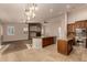 Open-concept design integrates a kitchen with granite island with a fireplace in the living room at 2183 W Hawken Way, Chandler, AZ 85286