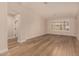 Spacious living room with light wood floors, bright lighting, and window shutters at 2183 W Hawken Way, Chandler, AZ 85286
