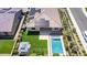 Drone shot of a beautiful backyard, including a sparkling pool, play area and covered patio, and solar panels at 22721 N 34Th St, Phoenix, AZ 85050