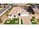 Aerial image of a desert home with a solar panels, manicured front yard, and green spaces, complete with solar panels at 22721 N 34Th St, Phoenix, AZ 85050