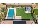 Aerial shot of a private backyard featuring a sparkling pool, play area, and covered patio for outdoor relaxation at 22721 N 34Th St, Phoenix, AZ 85050