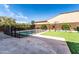 Large backyard with a paved patio, artificial grass, a pool with a fence, and a playground at 22721 N 34Th St, Phoenix, AZ 85050