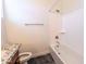 Clean bathroom featuring a tub-shower combo, sleek granite countertop, and stylish black marble flooring at 22721 N 34Th St, Phoenix, AZ 85050