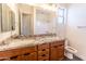 Bathroom vanity with double sinks, decorative countertop, and ample storage at 22721 N 34Th St, Phoenix, AZ 85050
