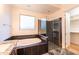 Bright bathroom featuring a soaking tub, glass shower, and walk-in closet at 22721 N 34Th St, Phoenix, AZ 85050