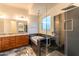 Modern bathroom featuring a soaking tub, granite countertops, and glass-enclosed shower at 22721 N 34Th St, Phoenix, AZ 85050