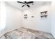 Unfurnished bedroom with tile floors, white walls, and mounted shelving at 22721 N 34Th St, Phoenix, AZ 85050