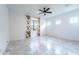 Light-filled bedroom featuring a ceiling fan, marble floors, and bright floral curtains at 22721 N 34Th St, Phoenix, AZ 85050